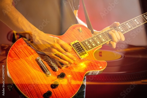 Man playing on modern guitar instrument. Music concept