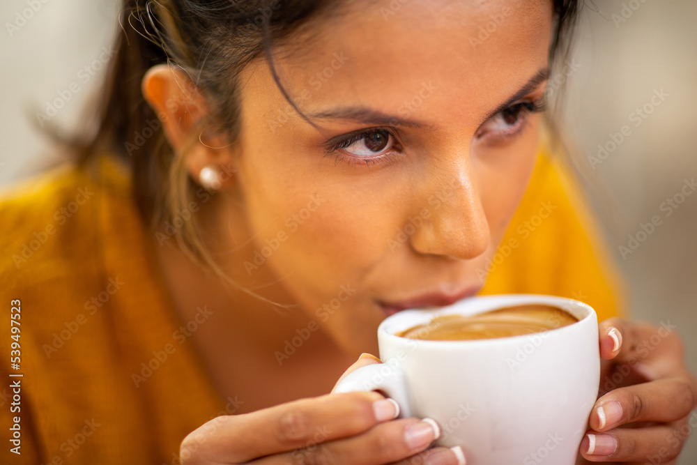 Close up young woman drinking hot cup of coffee Close up young woman drinking hot cup of coffee