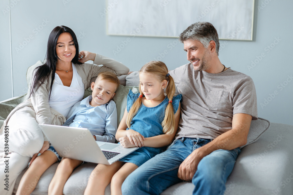 family with children using a laptop together in their free evening. family with children using a laptop together in their free evening.