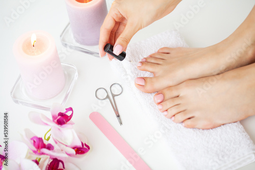 A woman does a pedicure on her own at home