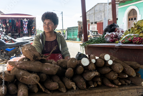 Mature latin woman selling vegetables in an informal market in Nicaragua