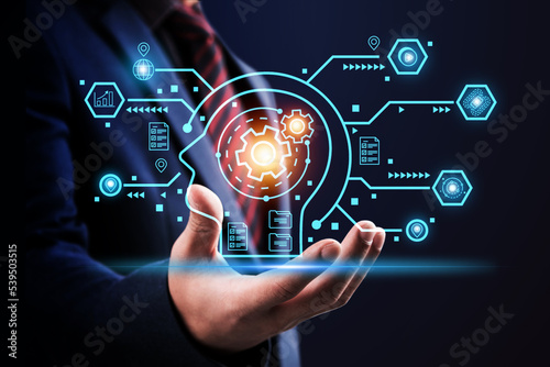 Businessman in suit touching the brain working of Artificial Intelligence (AI) in the futuristic business and coding software. Digital transformation technology strategy, IoT, internet AI