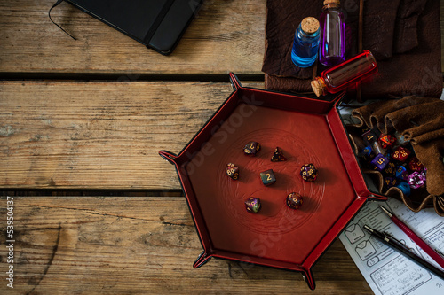 Overhead image of TTRPG equipment on a wooden table
