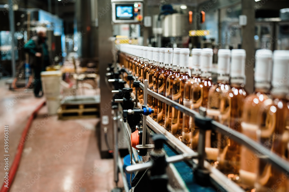 Industrial wine bottling plant theme. Modern industry production line for alcohol drink bottling and packaging. Industrial wine bottling plant theme. Modern industry production line for alcohol drink bottling and packaging.