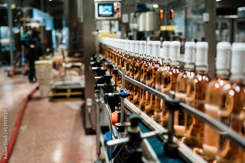 Industrial wine bottling plant theme. Modern industry production line for alcohol drink bottling and packaging.
