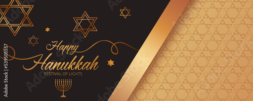 Festive banner with left side made up of golden text Happy Hanukkah, candlestick, stars of David on the black background and golden ornament and ribbon on the right side for Hanukkah Jewish holiday. 