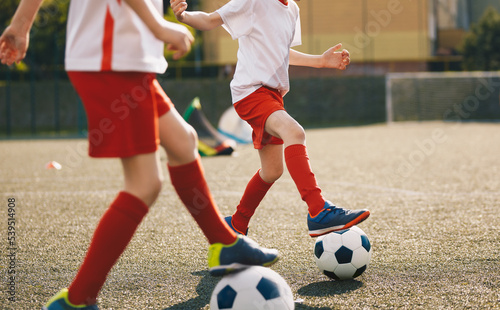 Two little boys on football soccer training at summer sunny day © matimix
