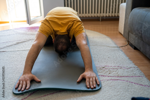 Man doing back stretch at home.