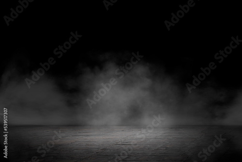Concrete floor with smoke or fog in dark room with spotlight. Asphalt night street. Mist on black background, black and white
