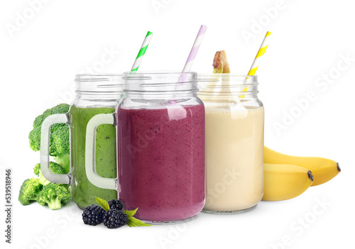 Different delicious smoothies in mason jars on white background