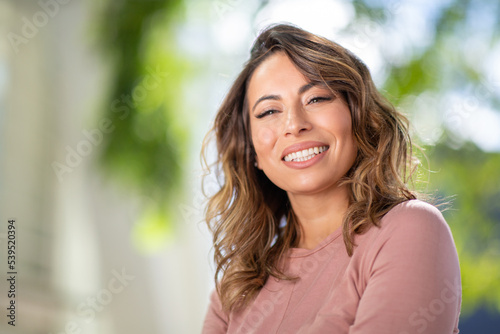 Close up smiling young woman outdoors