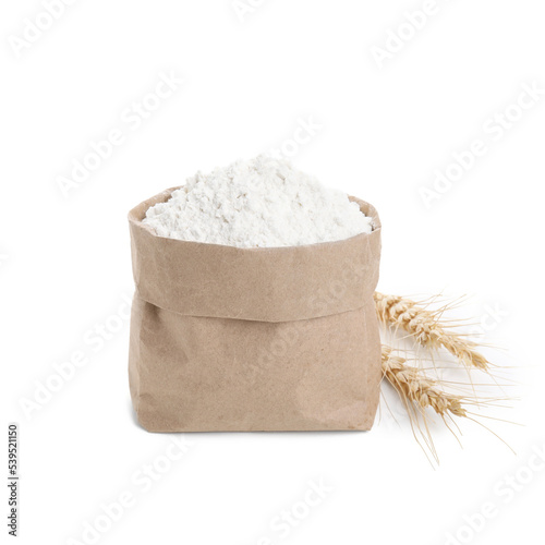 Paper bag with wheat flour and spikes isolated on white