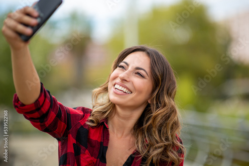 happy young woman taking selfie with cellphone