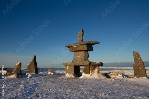 Inukshuk or Inuksuk found near Churchill, Manitoba with snow on the ground in early November, Canada.