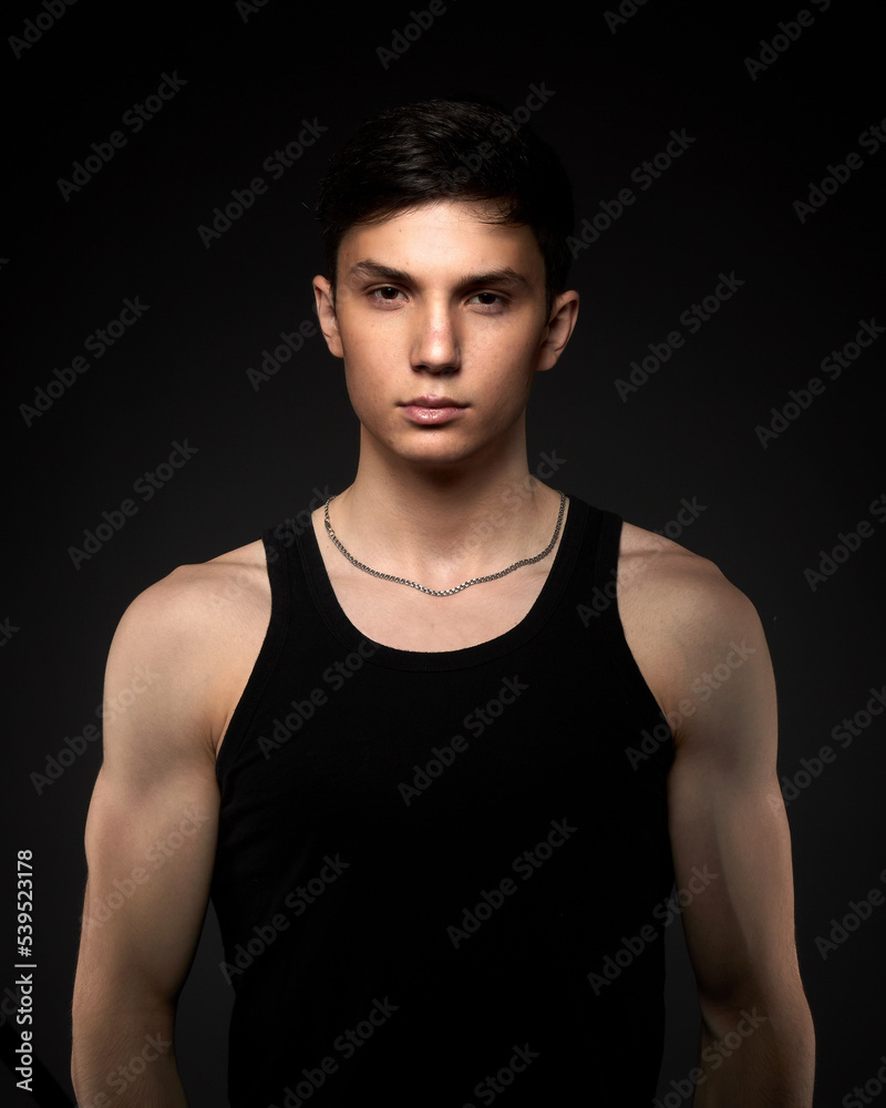 Fototapeta premium Teen athletic body on dark background