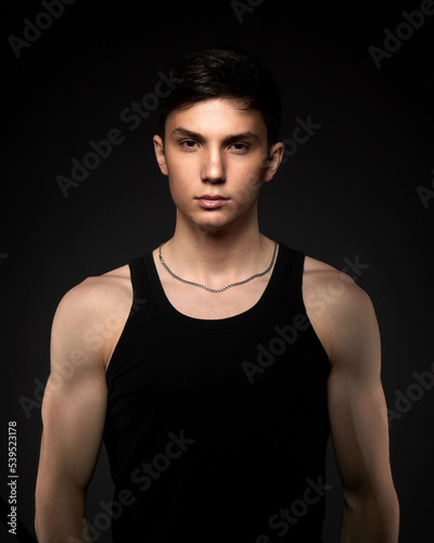 Teen athletic body on dark background