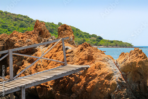 wood boardwalk with background  is mountain and blue sky