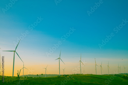 Wind turbines on beautiful sunny summer landsape. Green ecological power energy generation. Wind farm eco field © grooveriderz