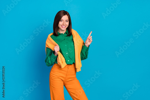 Photo of adorable lady wear sweatshirt shoulders nice outfit arm direct empty space black friday price isolated on blue color background