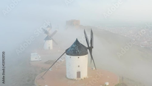 Typical old white Spanish windmills (Molinos appearing in Don Quijote) surrounded by a dry landscape in Consuegra, Toledo. Castilla la Mancha, Spain