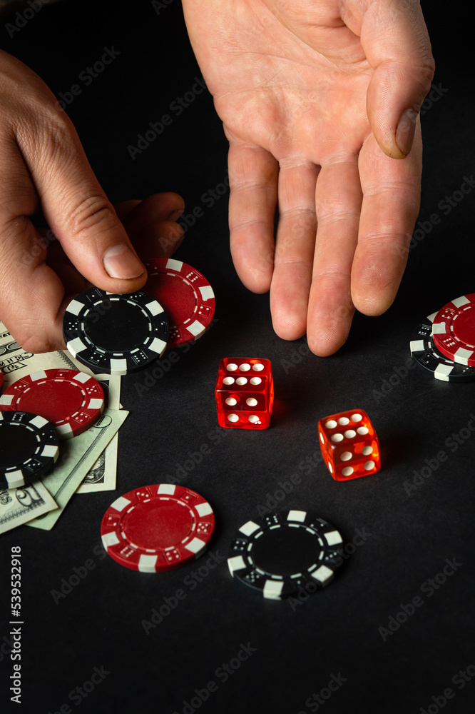 The player throws the dice on the table in the poker club. Luck or fortune in the casino The player throws the dice on the table in the poker club. Luck or fortune in the casino