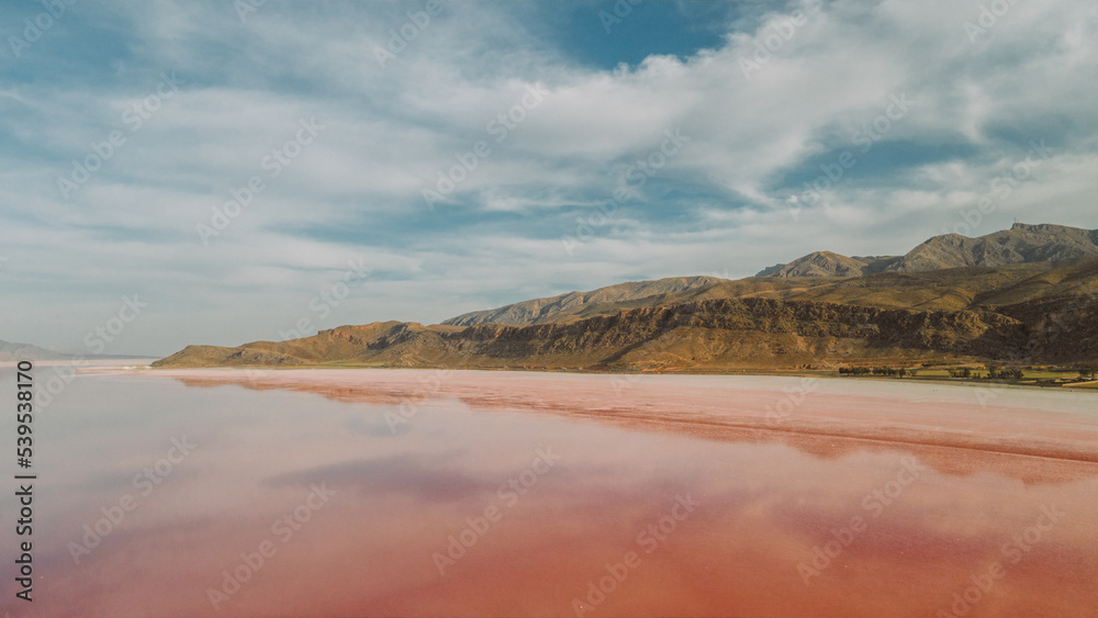 Pink lake near mountains on summer day Pink lake near mountains on summer day