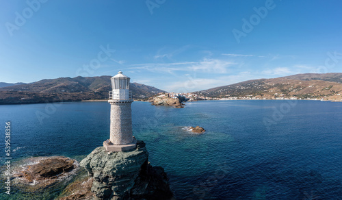 Fototapeta Naklejka Na Ścianę i Meble -  Greece.  Andros Island. The stone beacon on a rock aerial view. Chora town