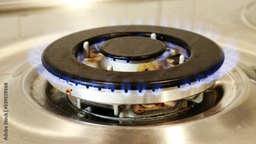 Gas cooker with burning flames of gas. Domestic kitchen with blue flames burning Gas cooker with burning flames of gas. Domestic kitchen with blue flames burning