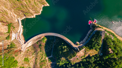 Aerial photography of Vidraru dam, in Romania. Photography was shot from a drone from above  the dam at Vidraru lake with the camera tilted straight down for a top view shot at the lake and dam.