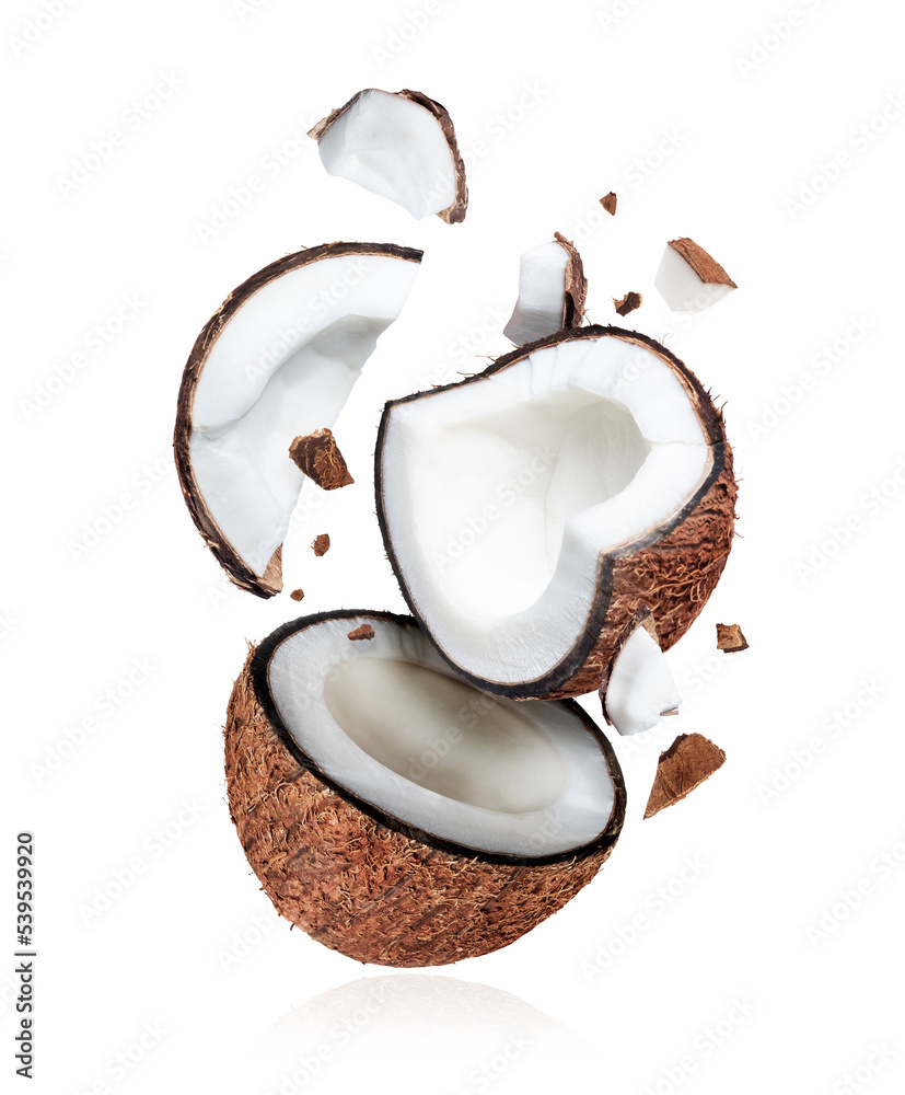 Broken coconut closeup in the air isolated on white background - obrazy, fototapety, plakaty 