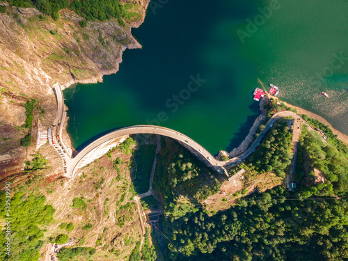 Aerial photography of Vidraru dam, in Romania. Photography was shot from a drone from above  the dam at Vidraru lake with the camera tilted straight down for a top view shot at the lake and dam.