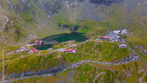 Drone photography of Balea lake, on Transfagarasan road, Romania. Photography was shot from a drone from a higher altitude with the lake and cabins in the view and the mountain in the background.  © Ioan