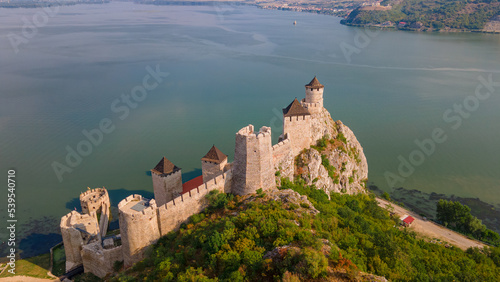 Aerial photography of Golubac fortress located on the Serbian side of the Danube river. Photography was shot from a drone with the Danube river in the background. photo
