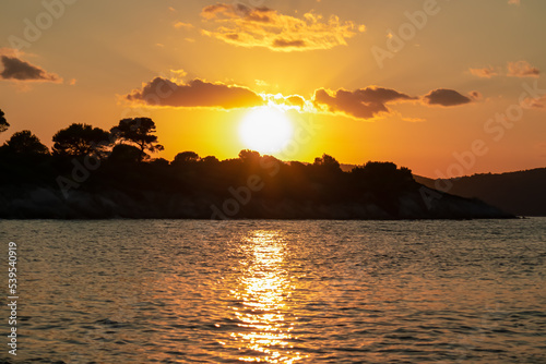 Panoramic view of coastline during sunset near Karydi beach, Vourvourou, Sithonia, Chalkidiki (Halkidiki), Greece, Europe. Vacation summer at Aegean Mediterranean Sea. Romantic atmosphere. Seascape