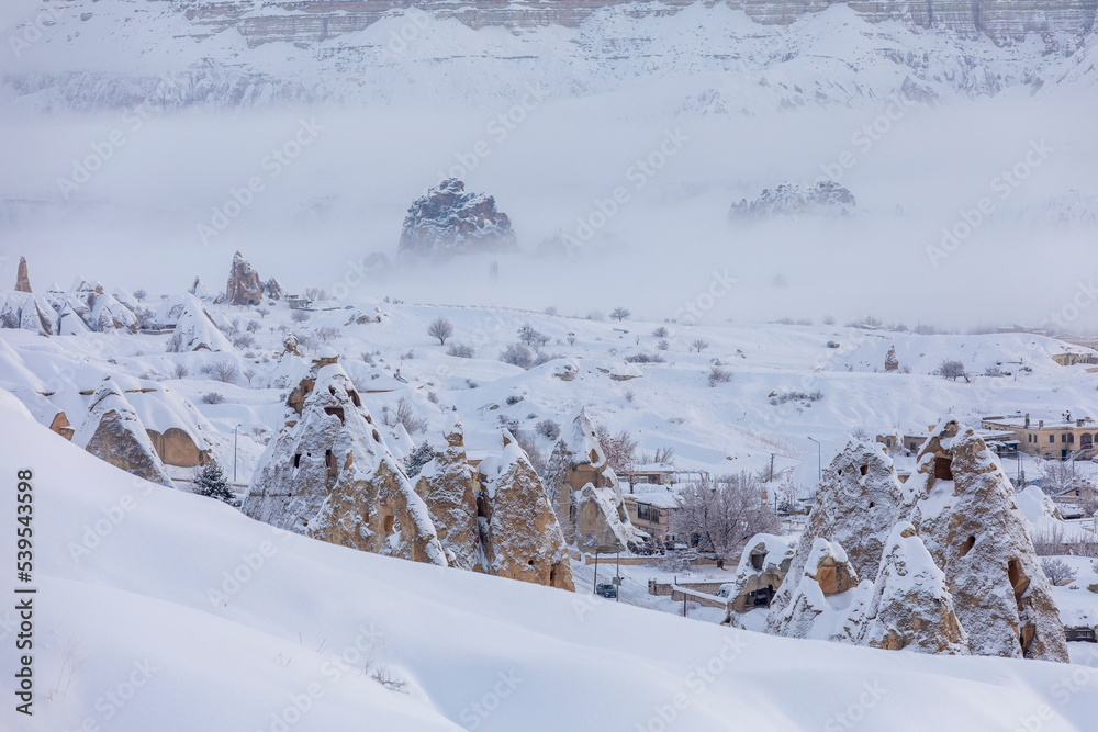 Pigeon Valley and Cave town in Goreme during winter time. Cappadocia, Turkey. Pigeon Valley and Cave town in Goreme during winter time. Cappadocia, Turkey.