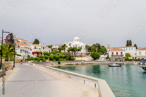 Beautiful View of Spetses Town with Traditional Neoclassic Buildings and White Cathedral Church by the Sea. Picturesque Bay in Saronic Gulf, Spetses Island, Greece