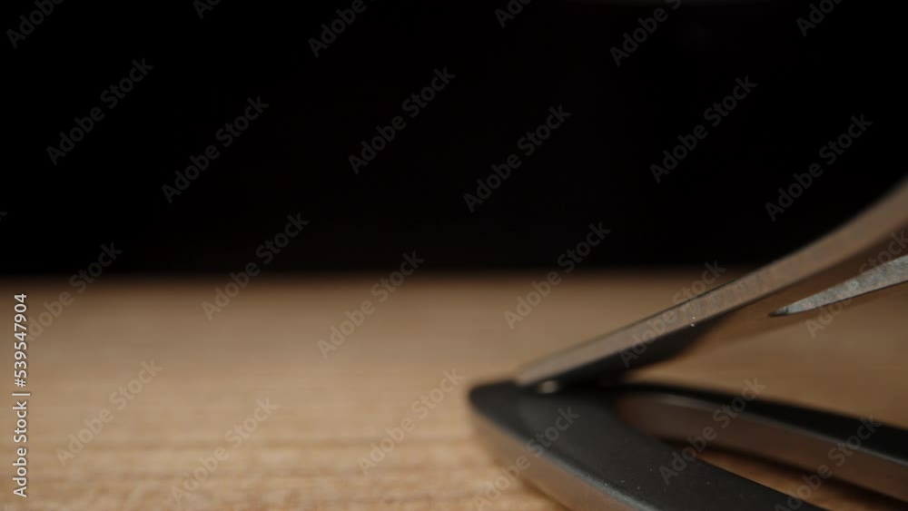 fingernail clipper on a black background. Dolly slider, extreme close-up. fingernail clipper on a black background. Dolly slider, extreme close-up.