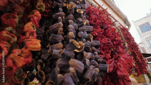 Dried vegetables hanging down on sale at market shop Grand Bazar, Istanbul Turkey. Dry eggplant, bell chili, stuffing and dressing  photo
