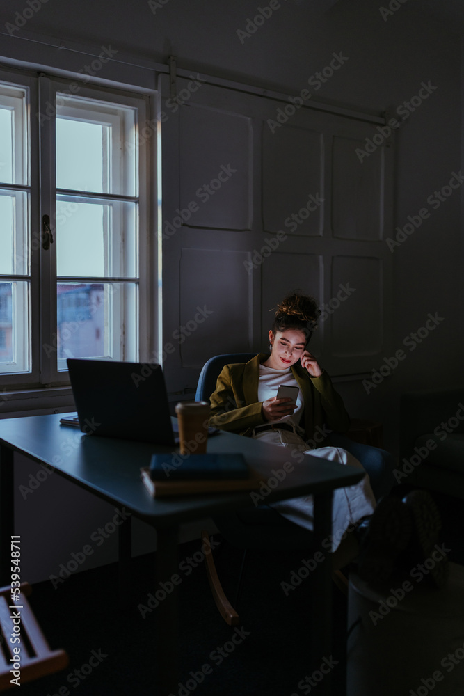Young women using her phone during the break Young women using her phone during the break