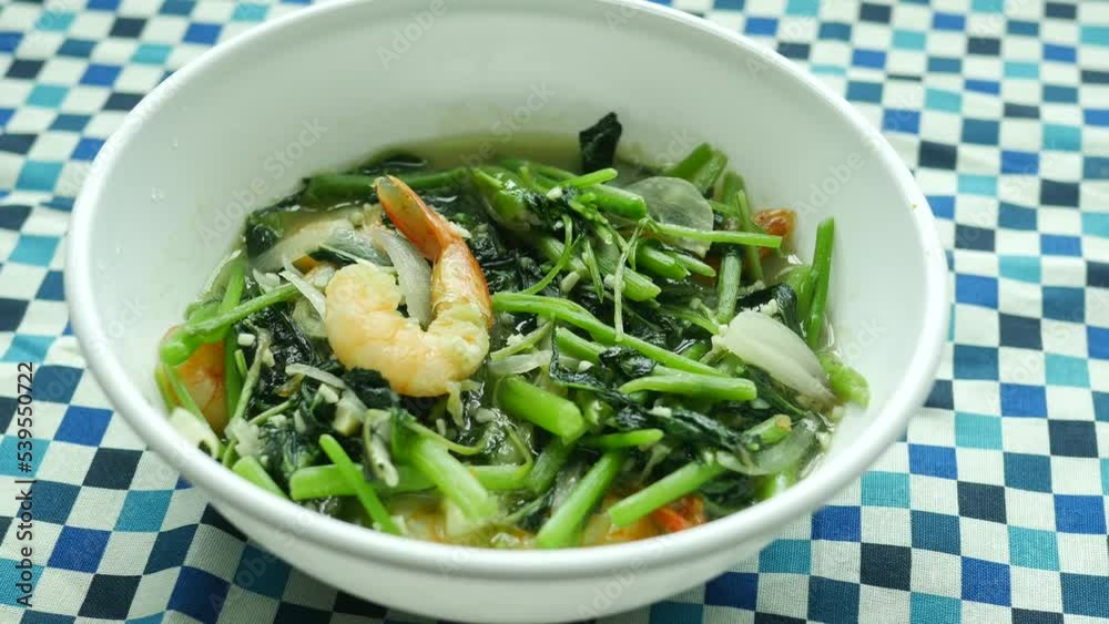 Top view of bowl with cooked spinach on table Top view of bowl with cooked spinach on table
