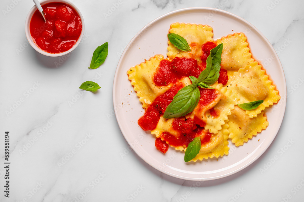 Delicious appetizing ravioli with tomato sauce and basil Delicious appetizing ravioli with tomato sauce and basil
