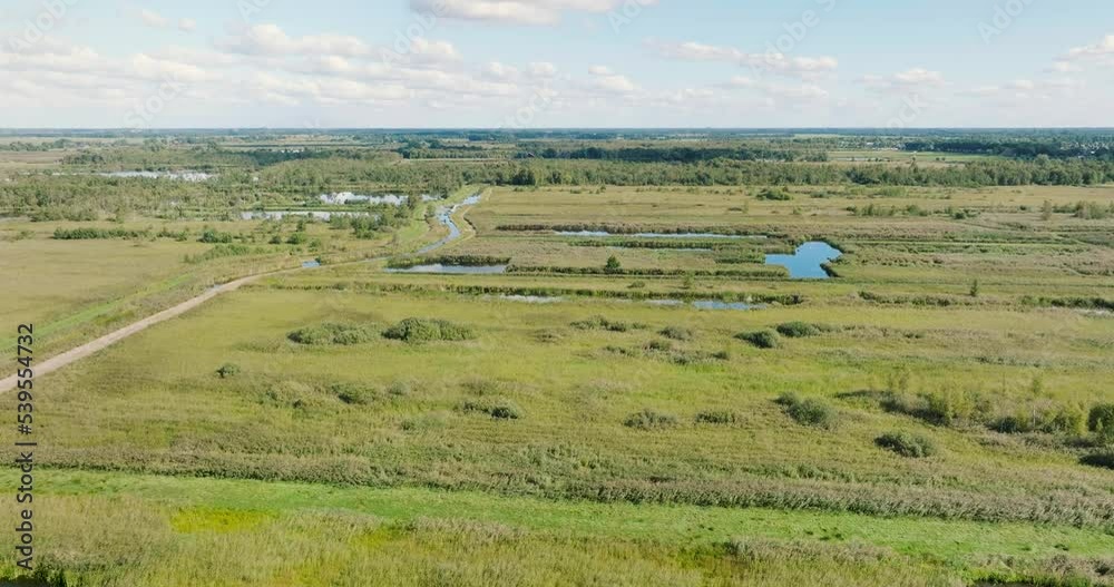 Aerial ascending view of reedland and peat bog in national park De Alde Feanen, Earnewald, Friesland, Netherlands Aerial ascending view of reedland and peat bog in national park De Alde Feanen, Earnewald, Friesland, Netherlands