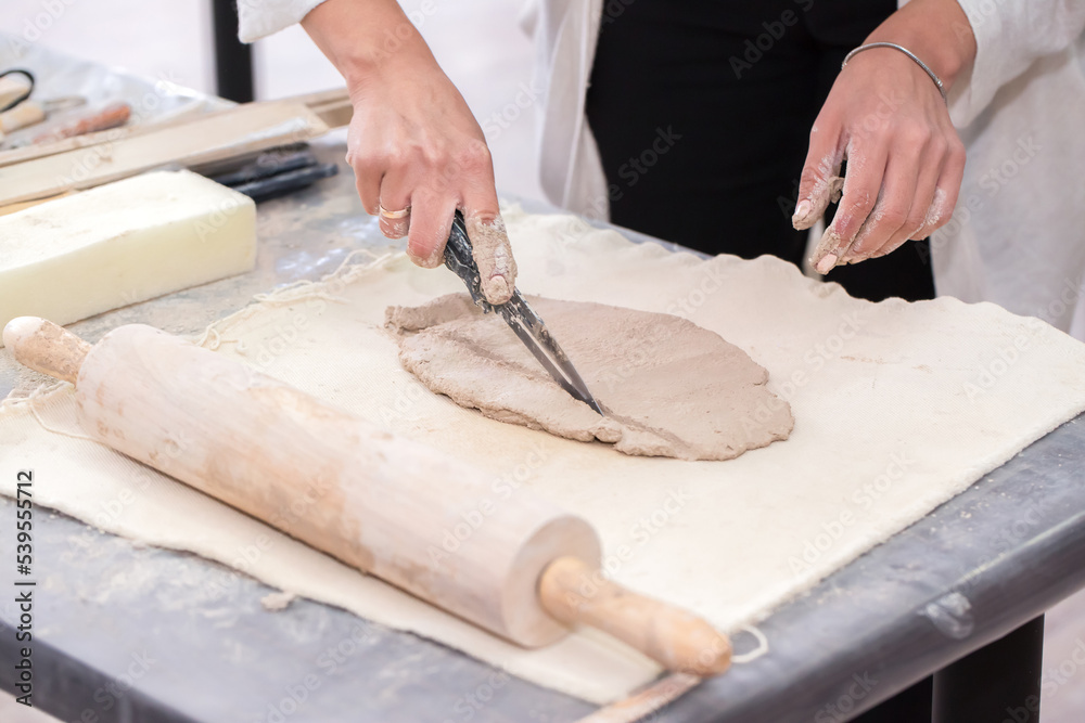 The sculptor sculpts a figurine out of clay with his hands. Creative workflow. Master of his craft. Sculptor's workshop. The sculptor sculpts a figurine out of clay with his hands. Creative workflow. Master of his craft. Sculptor's workshop.