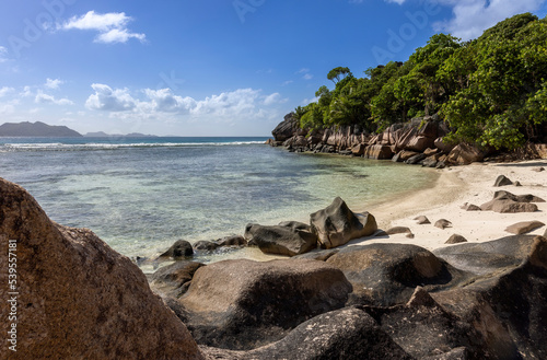Granite Rocks at a tropical beach on island La Digue in Seychellese