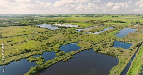 Aerial view of reedland, bushes and lakes with reflection of the sky in national park De Alde Feanen, Earnewald, Friesland, Netherlands photo