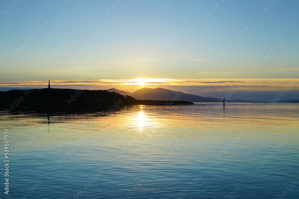 Sunset over Oban Bay and the entrance to Oban harbour with the isle of Kerrera in the back	
