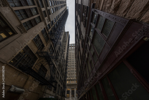 This image shows a POV perspective of a city goer looking up through Chicago skyscraper videos. 