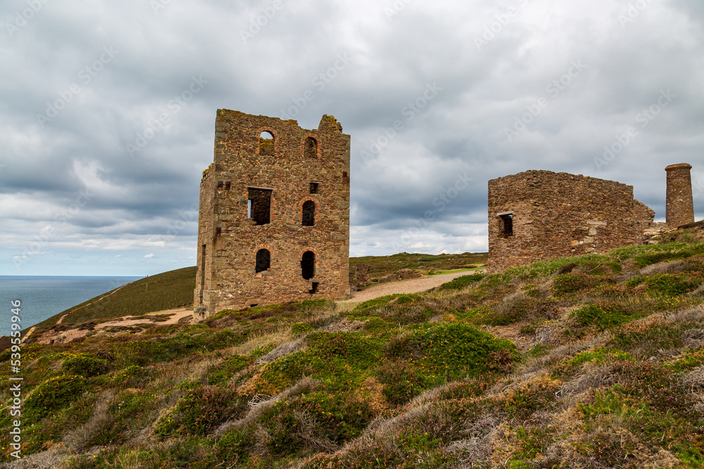 A view of the ruins of Wheal Coates Tin Mine in Cornwall, with the ocean behind