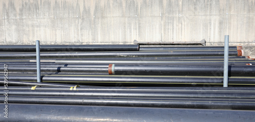 black pipes in the deposit of building material on the road construction site photo