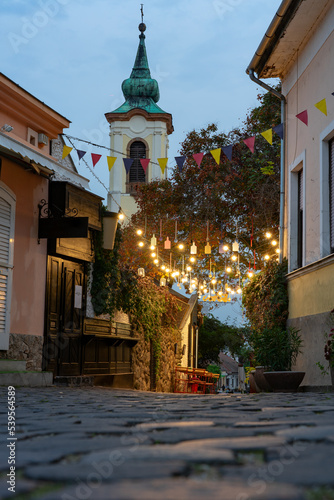 City square with beautiful city lights in Szentendre Hungary next to Budapest with colorful banner light decorations photo